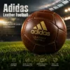 adidas leather football on grass